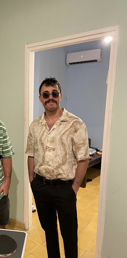 Stylish person posing by a doorway